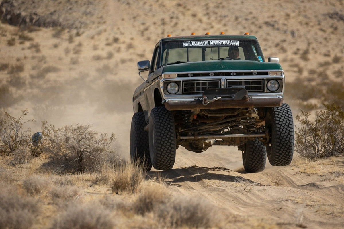 Harry’s green 1977 Highboy driving on a dusty desert trail