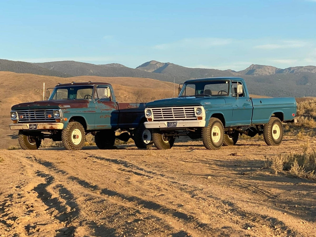 Brad’s two classic Ford trucks parked on a mountain dirt road